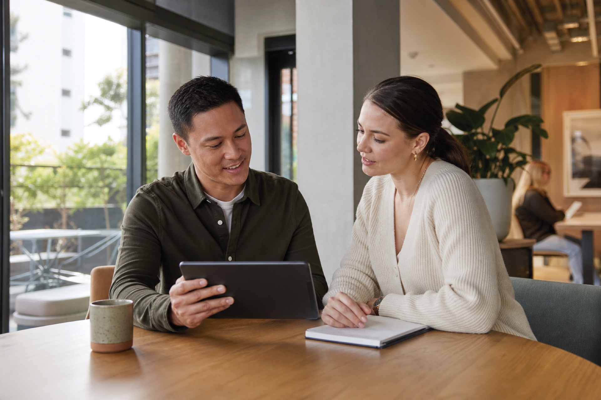 Tenant and property manager reviewing shared documents and account information together on a tablet